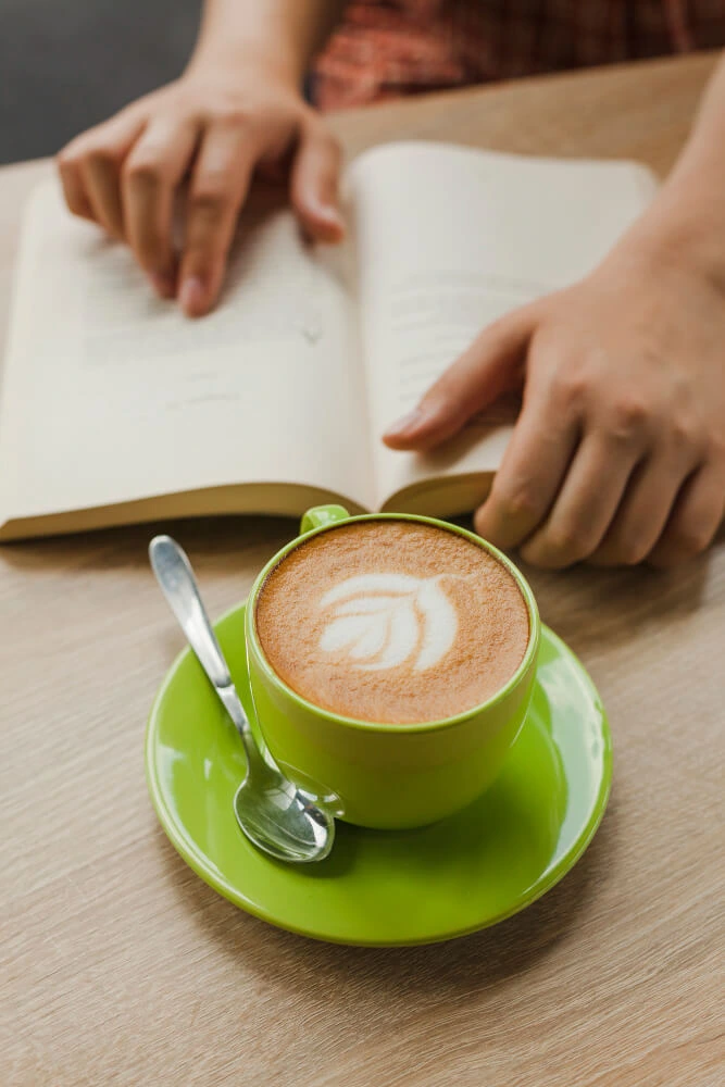 Person serving a cup of coffee