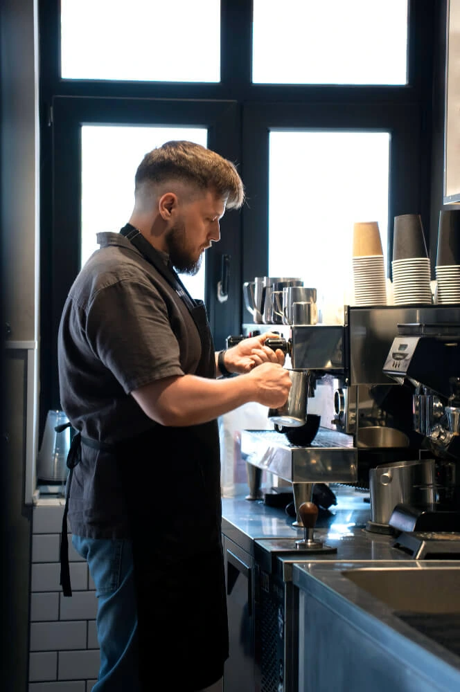 Person serving a cup of coffee