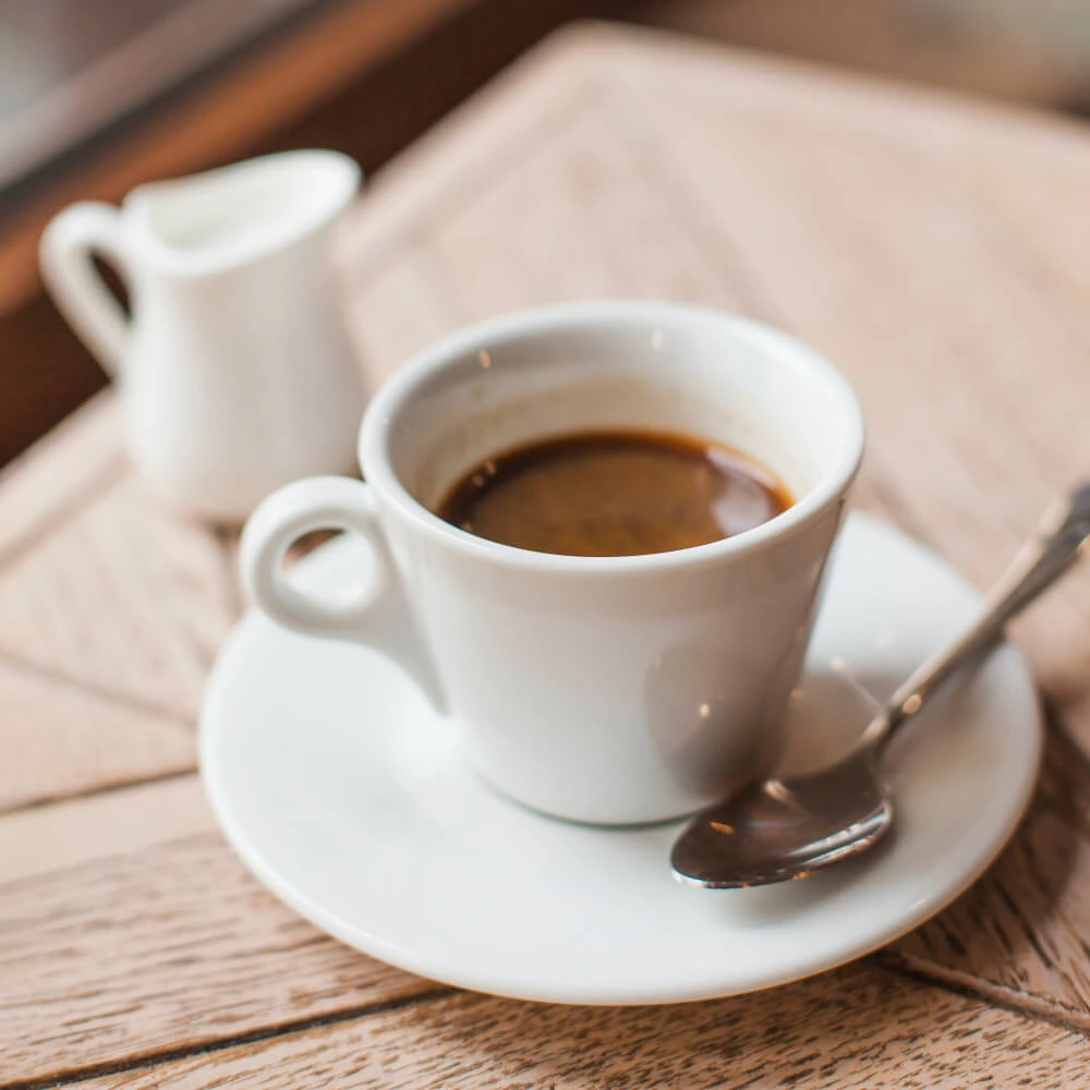 Close-up of coffee cup on wooden table in cafe