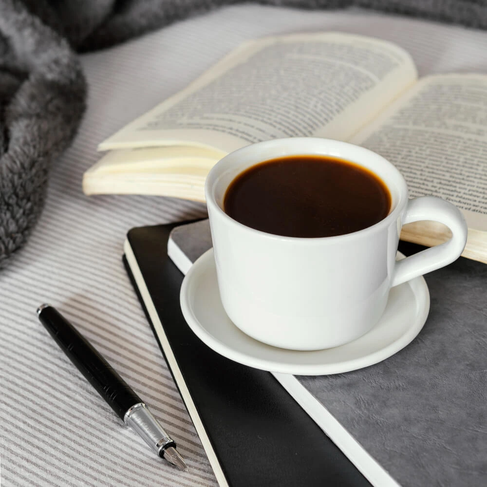 Close-up of coffee cup on wooden table in cafe