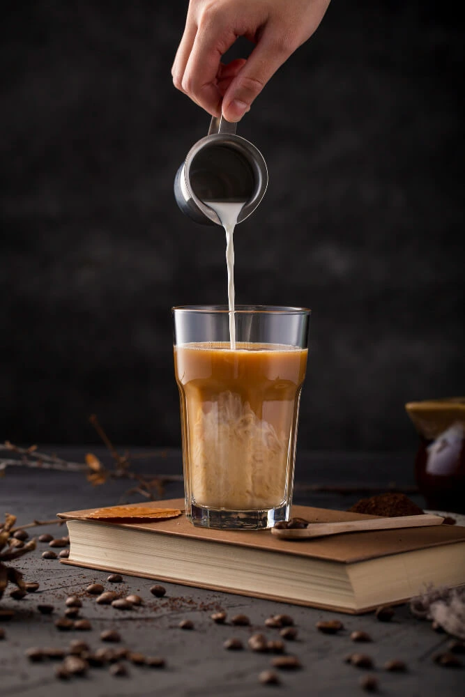 Person serving a cup of coffee