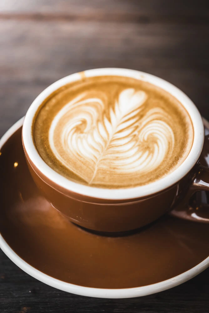 Person serving a cup of coffee